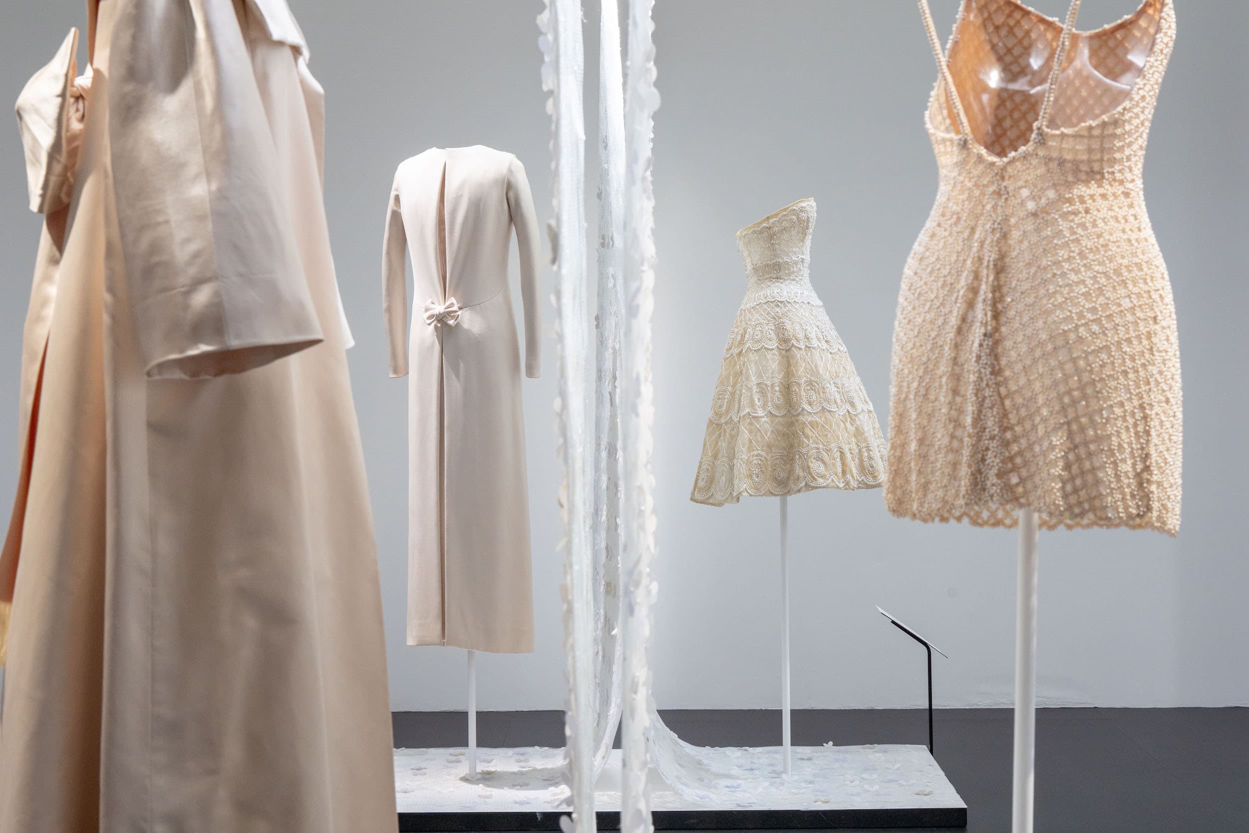 Azzedine Alaia and Christian Dior haute couture gowns displayed on mannequins in museum installation