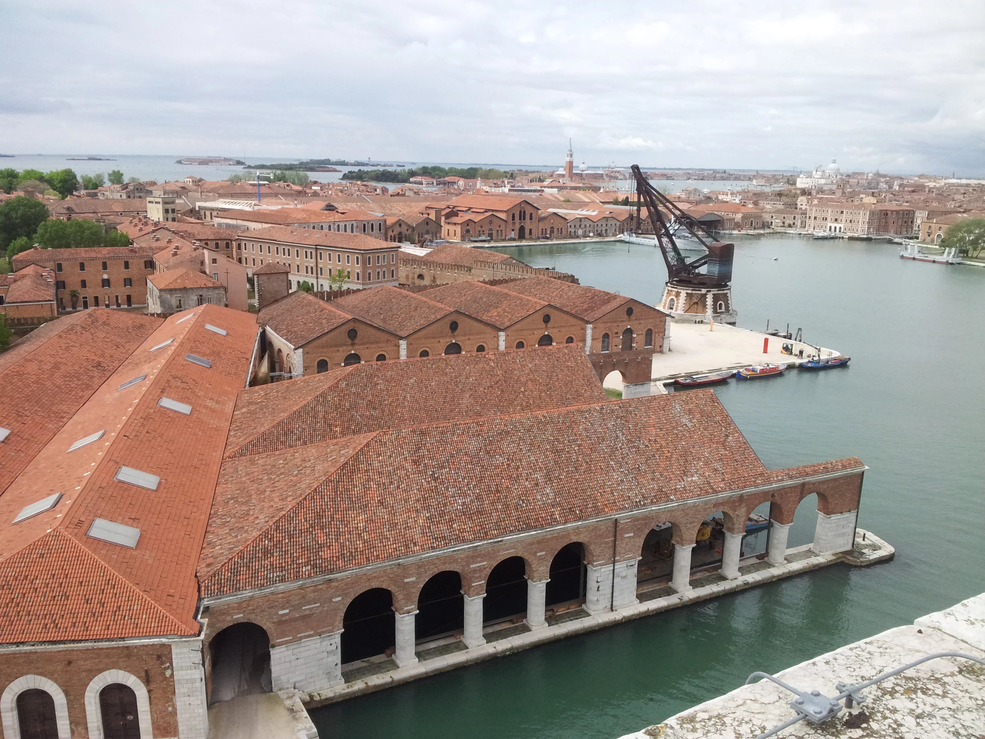 Aerial view of Venice Arsenale historic shipyard with red-tiled roofs and canal waterways