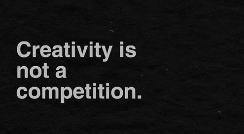 White text reading ‘Creativity is not a competition’ on a black textured background.