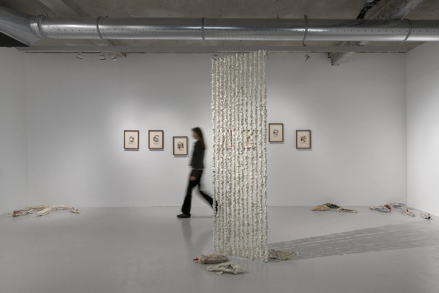 Installation view of Mirna Bamieh’s Sour Things: The Door exhibition at NIKA Project Space in Paris, featuring ceramic works, drawings, and hanging sculptural installation in a contemporary gallery space.