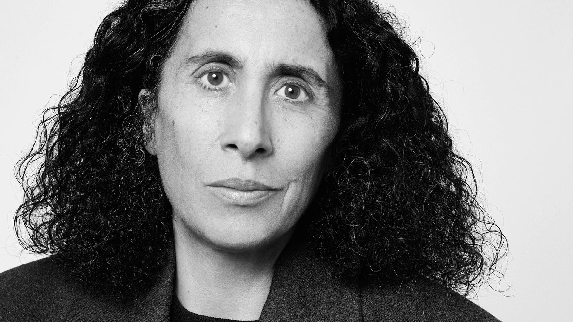 Sara Sozzani Maino black-and-white portrait, curly dark hair, photographed by Illya Ovchar, 2024