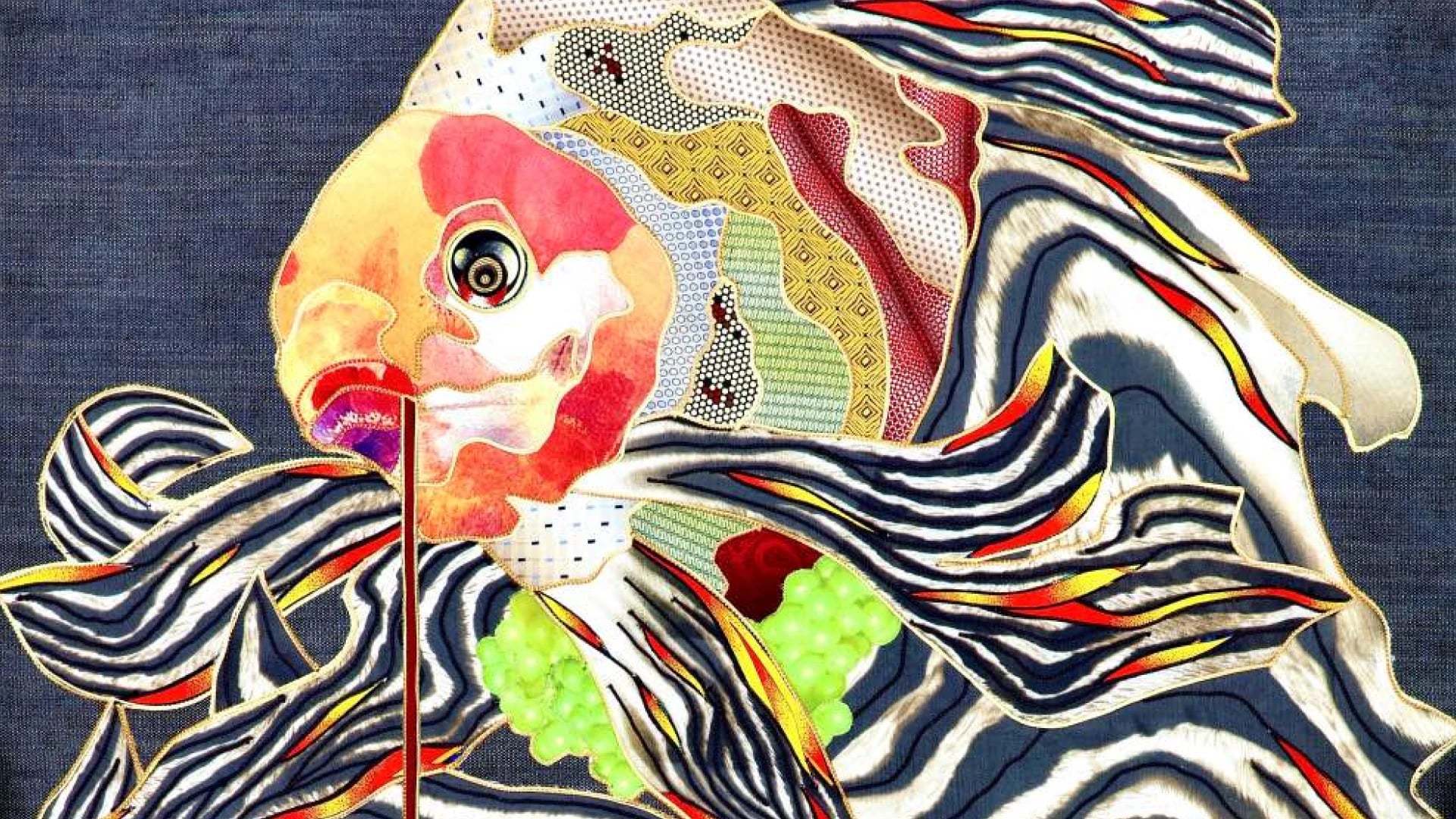 Kostyantin Malginov silk tapestry featuring a koi fish composed of vibrant patchwork fabrics with bold zebra-stripe fins