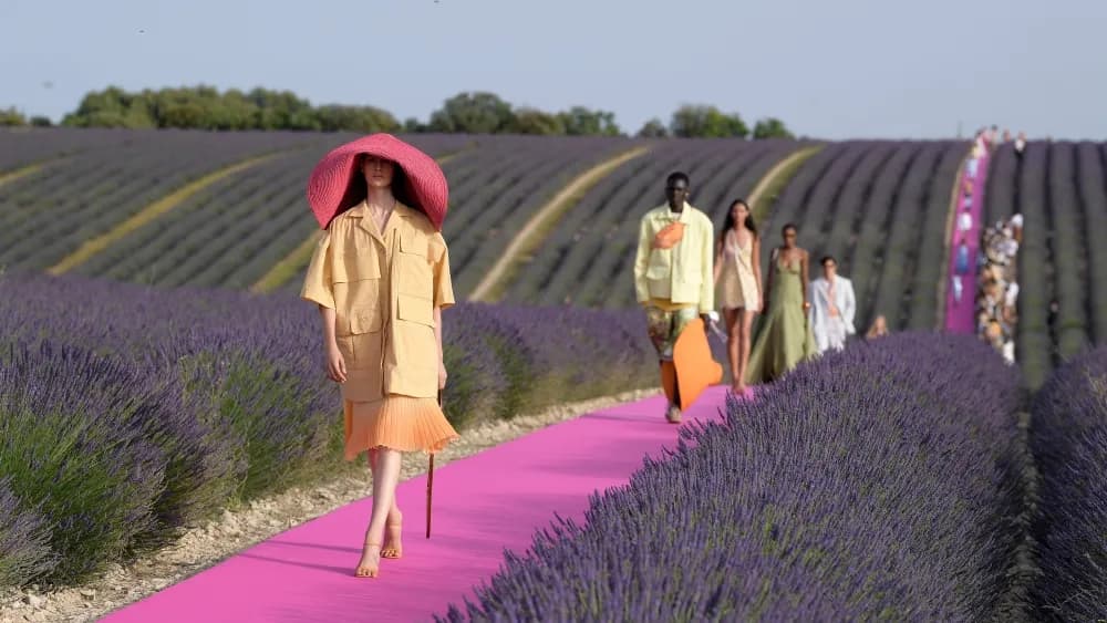 Hot-pink runway laid through a blooming purple lavender field in Valensole, France, for a Jacquemus fashion show.